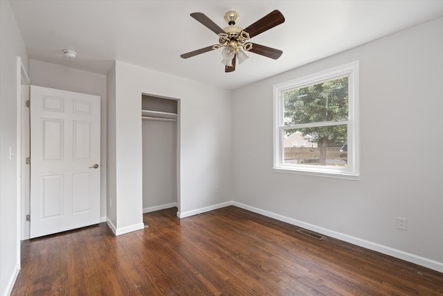 unfurnished bedroom featuring a closet, ceiling fan, and dark hardwood / wood-style flooring