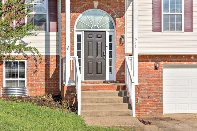 doorway to property with a garage