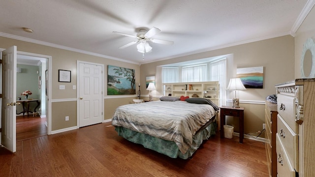 bedroom featuring ceiling fan, crown molding, and dark hardwood / wood-style floors