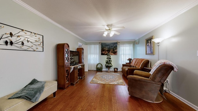 living room with crown molding, hardwood / wood-style floors, and ceiling fan