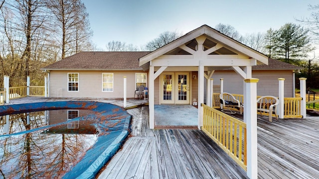 rear view of property featuring a wooden deck