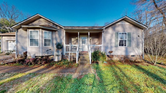 ranch-style house featuring a porch and a front lawn