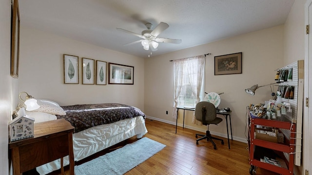 bedroom featuring hardwood / wood-style flooring and ceiling fan