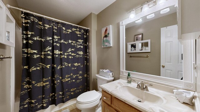 bathroom with vanity, curtained shower, and toilet