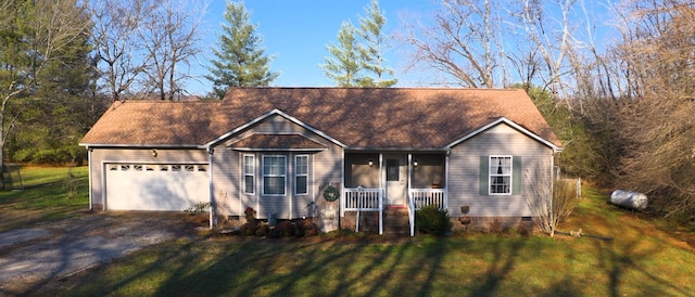 ranch-style home featuring covered porch, a front yard, and a garage