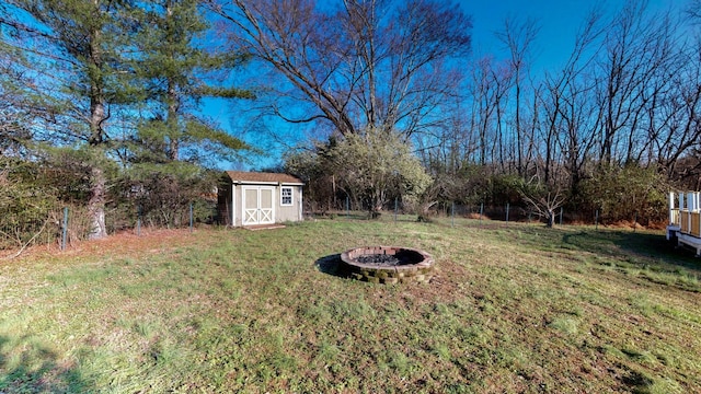 view of yard with a storage unit and an outdoor fire pit