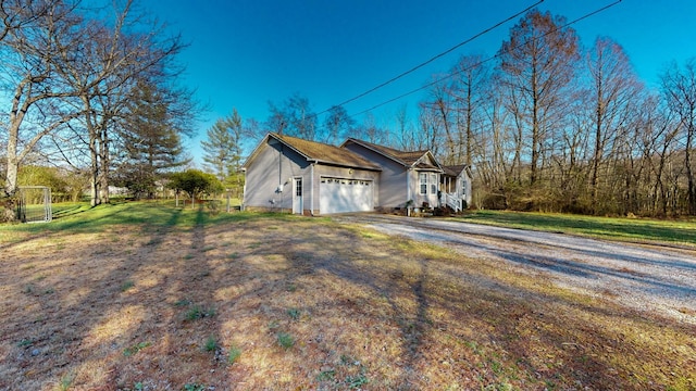 view of property exterior featuring a lawn and a garage