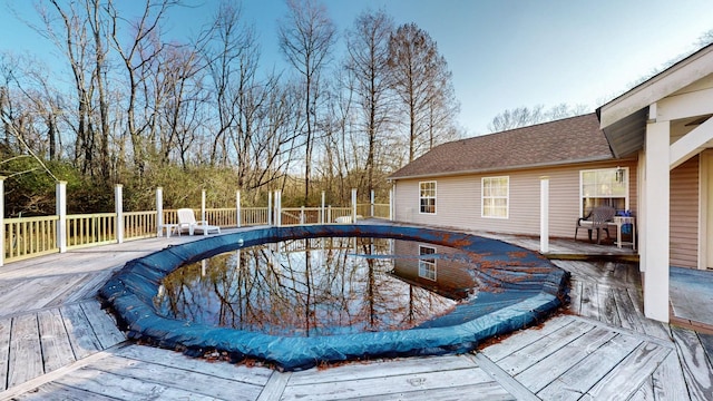 view of swimming pool with a wooden deck