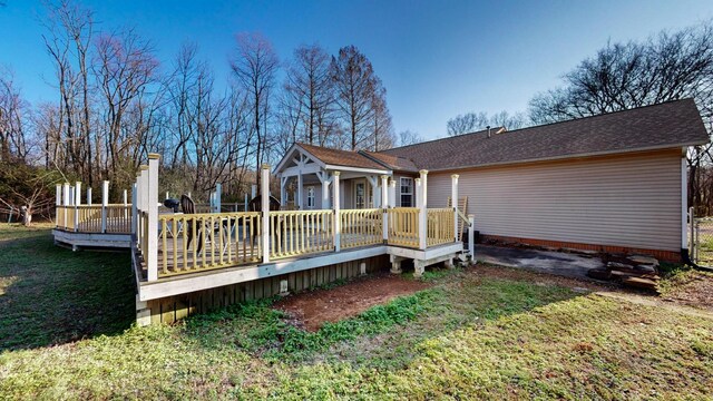 back of house featuring a yard and a deck