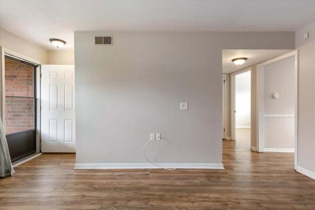 unfurnished room with dark hardwood / wood-style flooring