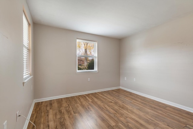 spare room with hardwood / wood-style floors