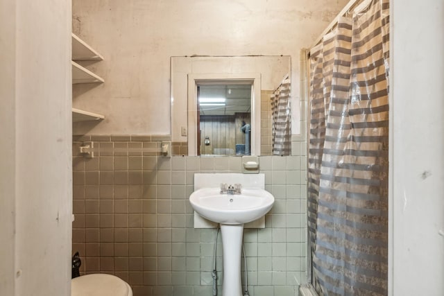 bathroom featuring tile walls and walk in shower