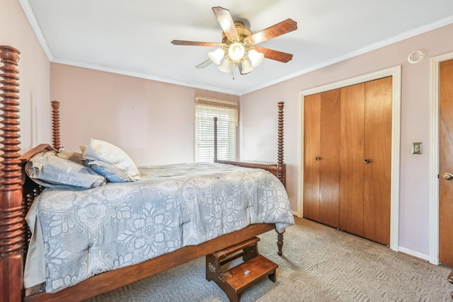 carpeted bedroom with a closet, ceiling fan, and ornamental molding