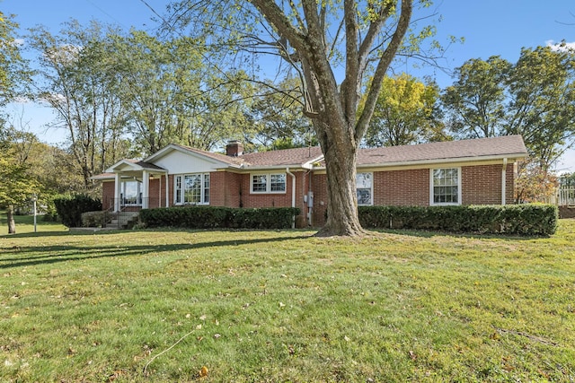 ranch-style home with a front lawn