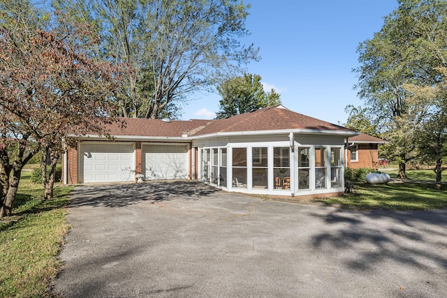 exterior space with a sunroom and a garage