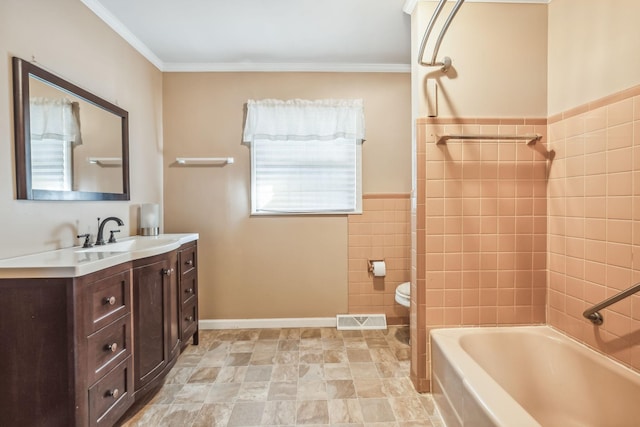 full bathroom featuring crown molding, toilet, vanity, tile walls, and tiled shower / bath