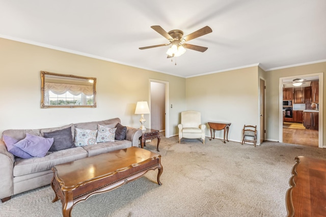 carpeted living room featuring ceiling fan, sink, and crown molding