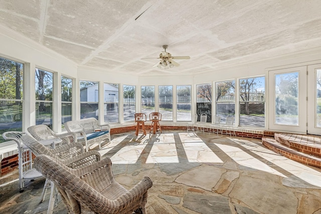 unfurnished sunroom with plenty of natural light and ceiling fan