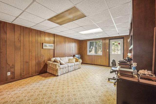 office area featuring a paneled ceiling and wood walls