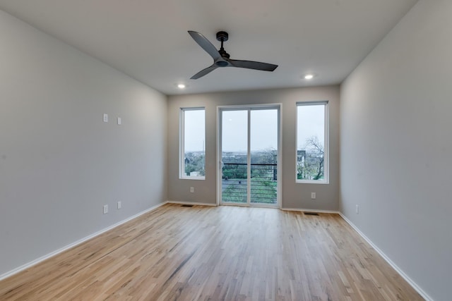 spare room with light hardwood / wood-style flooring and ceiling fan