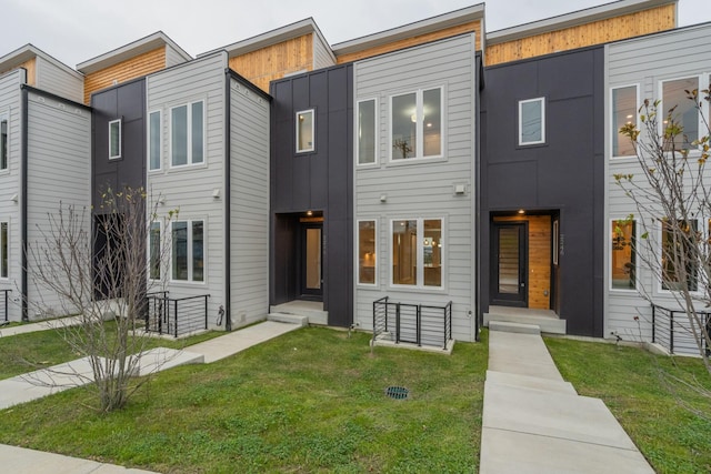 contemporary home featuring a front lawn