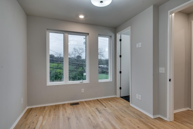 spare room featuring light hardwood / wood-style flooring