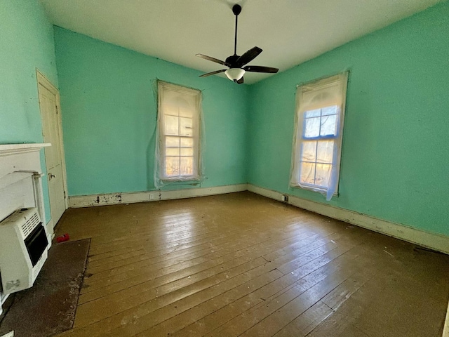 interior space with heating unit, hardwood / wood-style flooring, and plenty of natural light