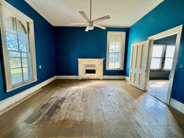 unfurnished living room featuring wood-type flooring, ceiling fan, and ornamental molding