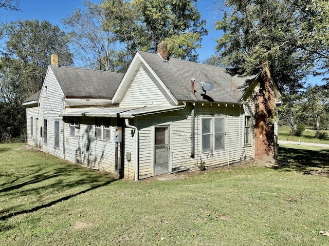 rear view of house with a yard