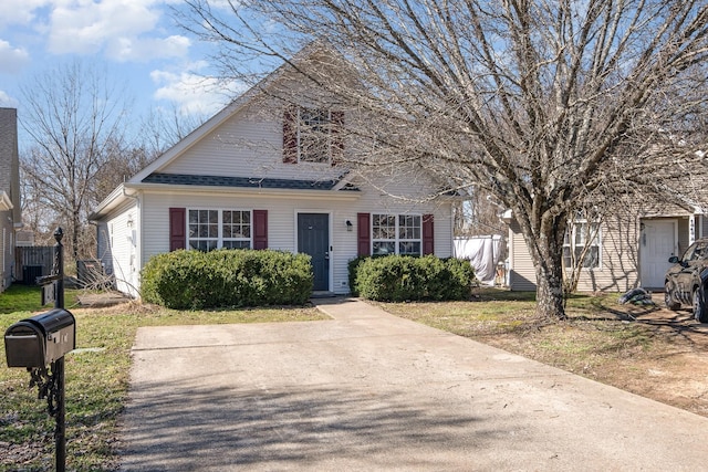 bungalow-style home with roof with shingles