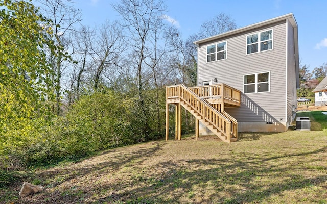 back of property featuring a yard, a deck, and central air condition unit