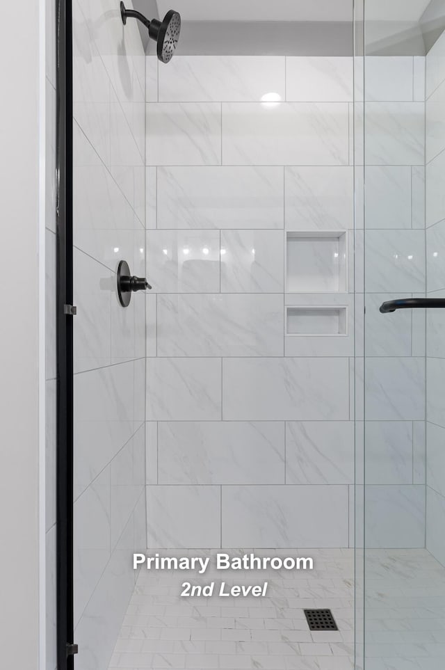 bathroom featuring a shower with shower door