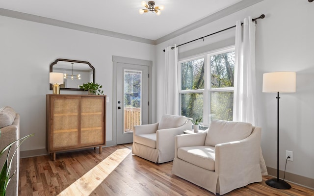 living area with wood-type flooring and an inviting chandelier