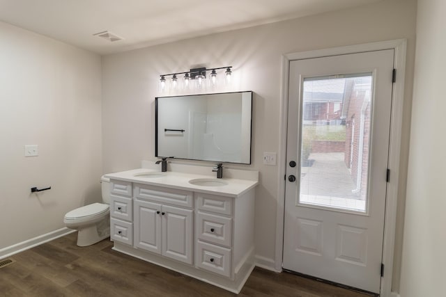 bathroom with vanity, toilet, and wood-type flooring