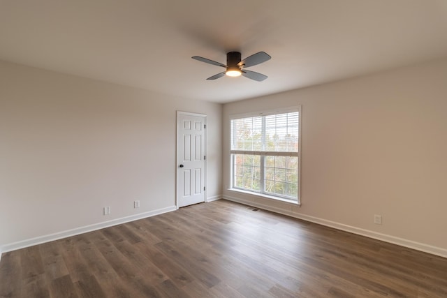 empty room with ceiling fan and dark hardwood / wood-style floors