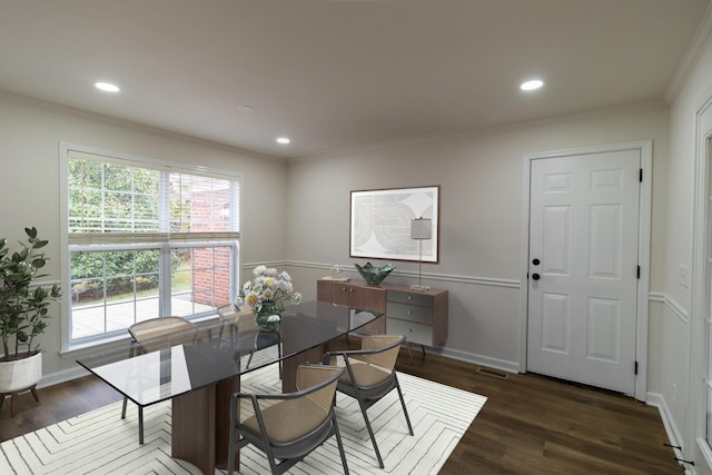 dining room featuring dark wood-type flooring and ornamental molding