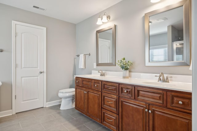 bathroom featuring tile patterned floors, vanity, and toilet