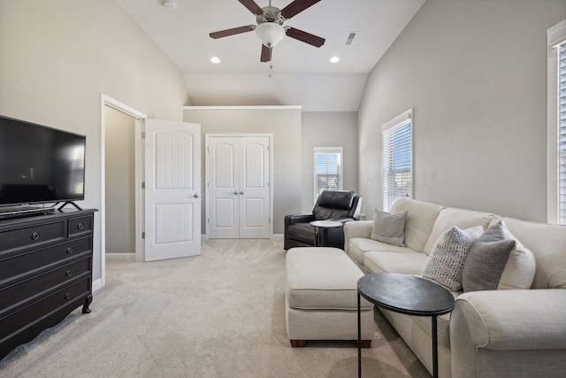 living room featuring ceiling fan, high vaulted ceiling, and light colored carpet