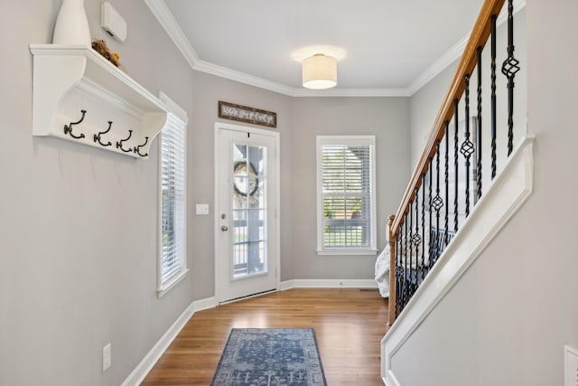 entryway with light hardwood / wood-style floors and ornamental molding