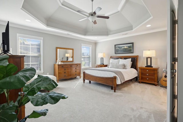 carpeted bedroom featuring a raised ceiling, ceiling fan, and ornamental molding