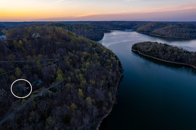 aerial view at dusk with a water view