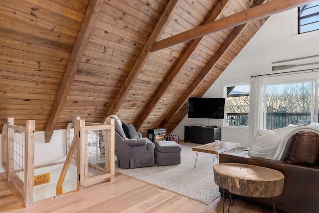 interior space with a healthy amount of sunlight, wooden ceiling, lofted ceiling with beams, and light wood-type flooring