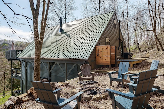 view of side of home featuring a fire pit