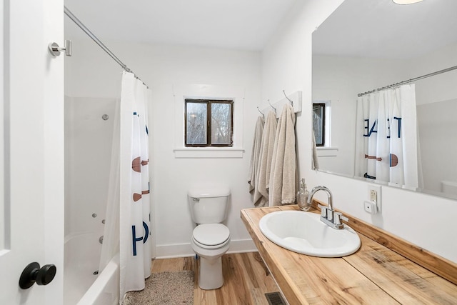 full bathroom with hardwood / wood-style floors, vanity, shower / bath combination with curtain, and toilet