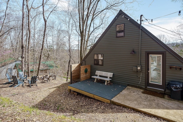 back of property with a wooden deck