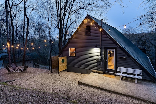 view of back house at dusk