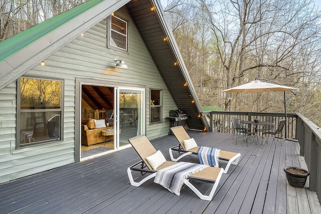 wooden terrace featuring area for grilling