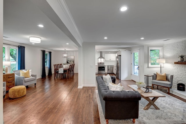 living room featuring hardwood / wood-style flooring and crown molding