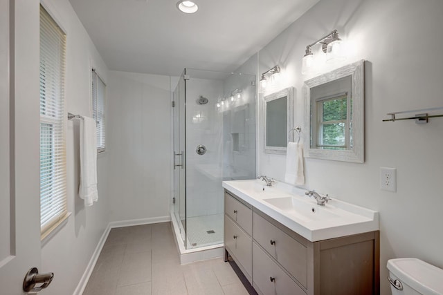 bathroom with tile patterned floors, vanity, toilet, and walk in shower