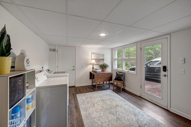 laundry area with dark hardwood / wood-style flooring and washer and clothes dryer